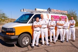 George Brazil HVAC technicians outside in Phoenix, AZ in front of a branded work van.