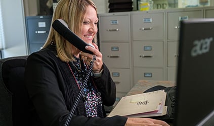 Customer service representative speaking on phone