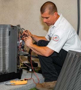 George Brazil HVAC technician running diagnostic testing on an AC unit.