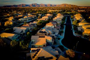 Aerial view of a residential neighborhood in Surprize, AZ as the sun is setting.