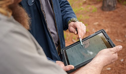 Technician reviewing financing details on tablet Technician reviewing financing details on tablet