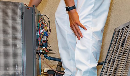 George Brazil HVAC technician installing outdoor AC unit George Brazil HVAC technician installing outdoor AC unit