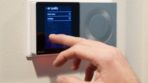 A-smart-thermostat-being-operated-by-a-customer-768x513-1 Customer adjusting a smart thermostat installed by George Brazil Air Conditioning & Heating.